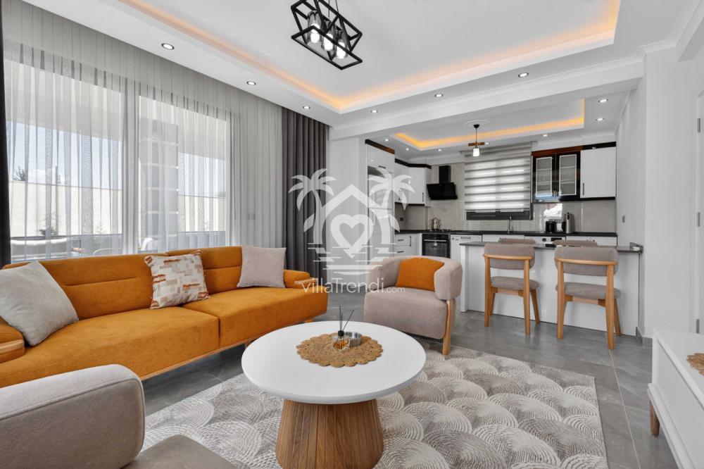 Seydikemer muhafazakar villa Doğa ferah salon ve turuncu oturma grubu.